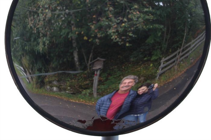 Dan and Rudi (Happy Mango owners) looking into a traffic mirror in Italy.
